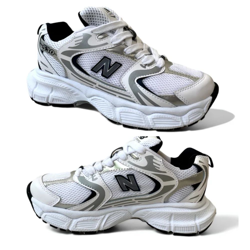 Tenis NB530 en color blanco y negro con diseño moderno y suela premium. Combinados con un outfit casual, mostrando su versatilidad.